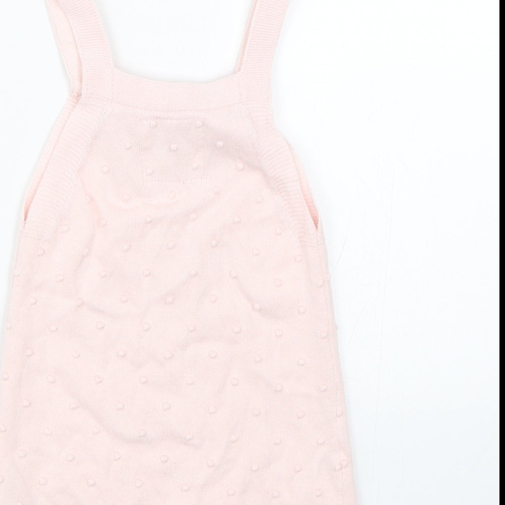 Brand and care label for F&F girls’ pink polka dot tank dress, size 9-12, months