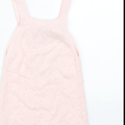 Brand and care label for F&F girls’ pink polka dot tank dress, size 9-12, months