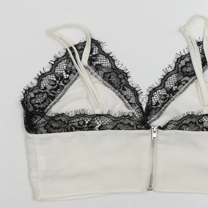 Brand and care label for Missguided women’s white cropped tank, size UK 4