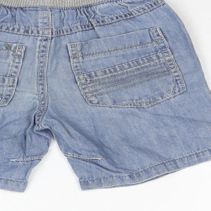 Brand and care label for Next girls’ blue ikat cropped jeans, size 9-12, months