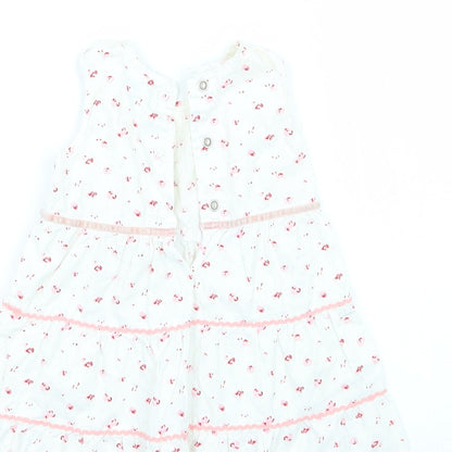 Brand and care label for Adams girls’ white floral a-line, size 3-6, months