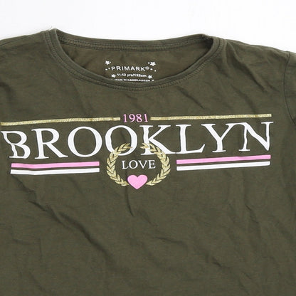 Close-up detail of Primark girls’ green basic t-shirt, size 11-12, years
