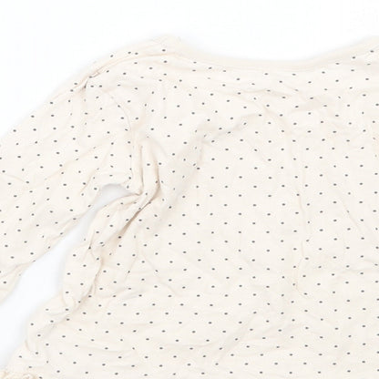 Brand and care label for George girls’ ivory polka dot basic t-shirt, size 9-12, months
