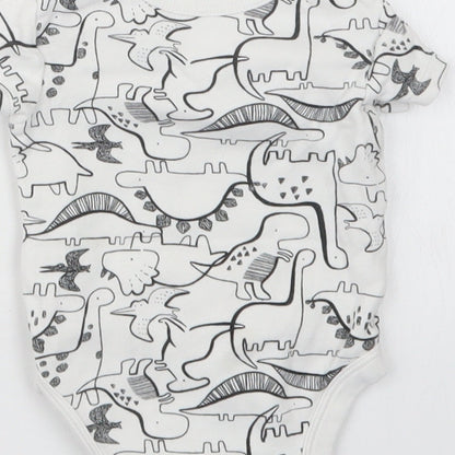 Brand and care label for Tu boys’ white geometric babygrow one-piece, size 0-3, months