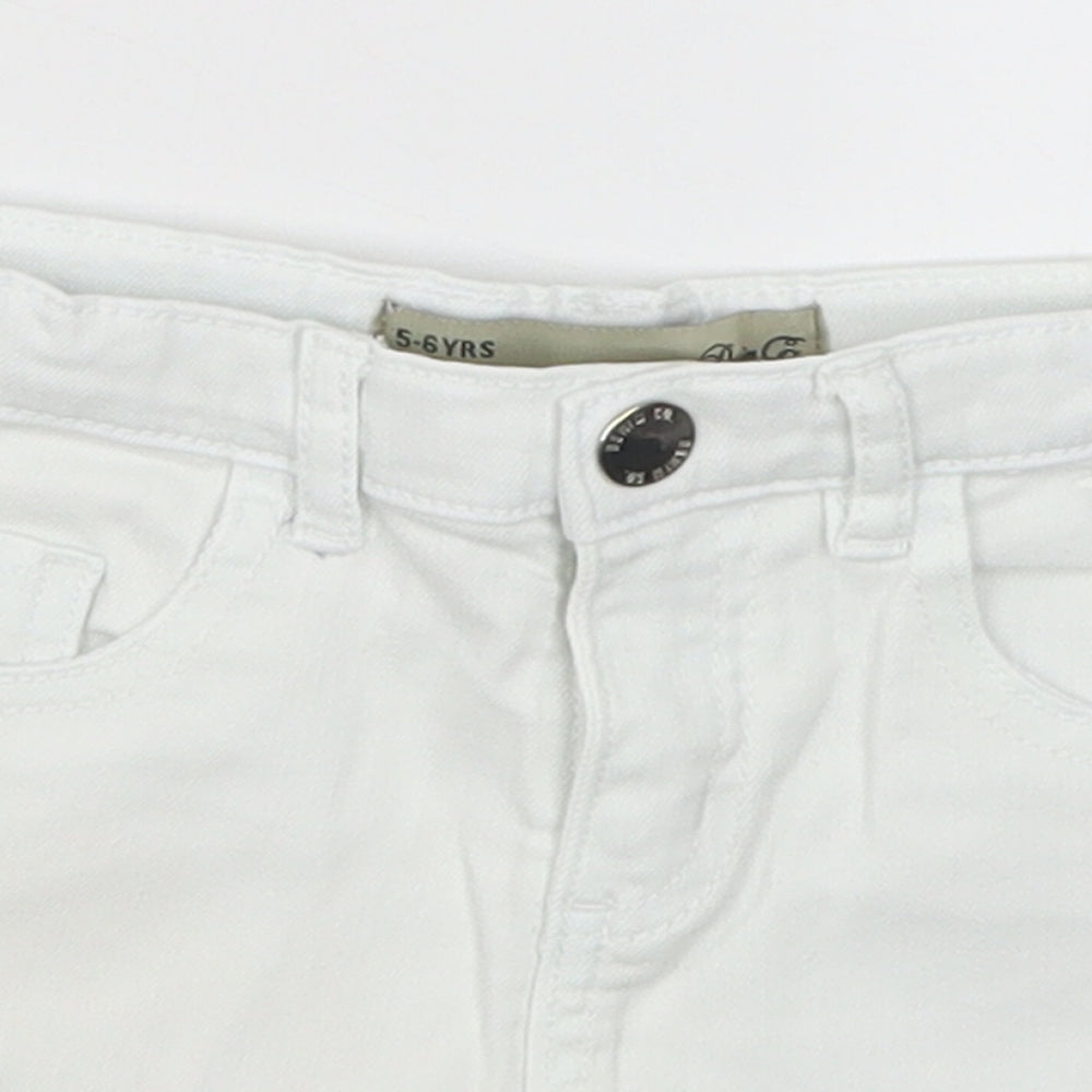 Close-up detail of Denim Co girls’ white denim cut-off shorts, size 5-6, years - pom pom
