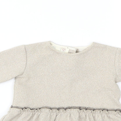 Close-up detail of Zara girls’ beige a-line, size 9-12, months