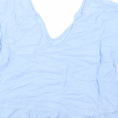Brand and care label for ASOS women’s blue basic blouse, size UK 10