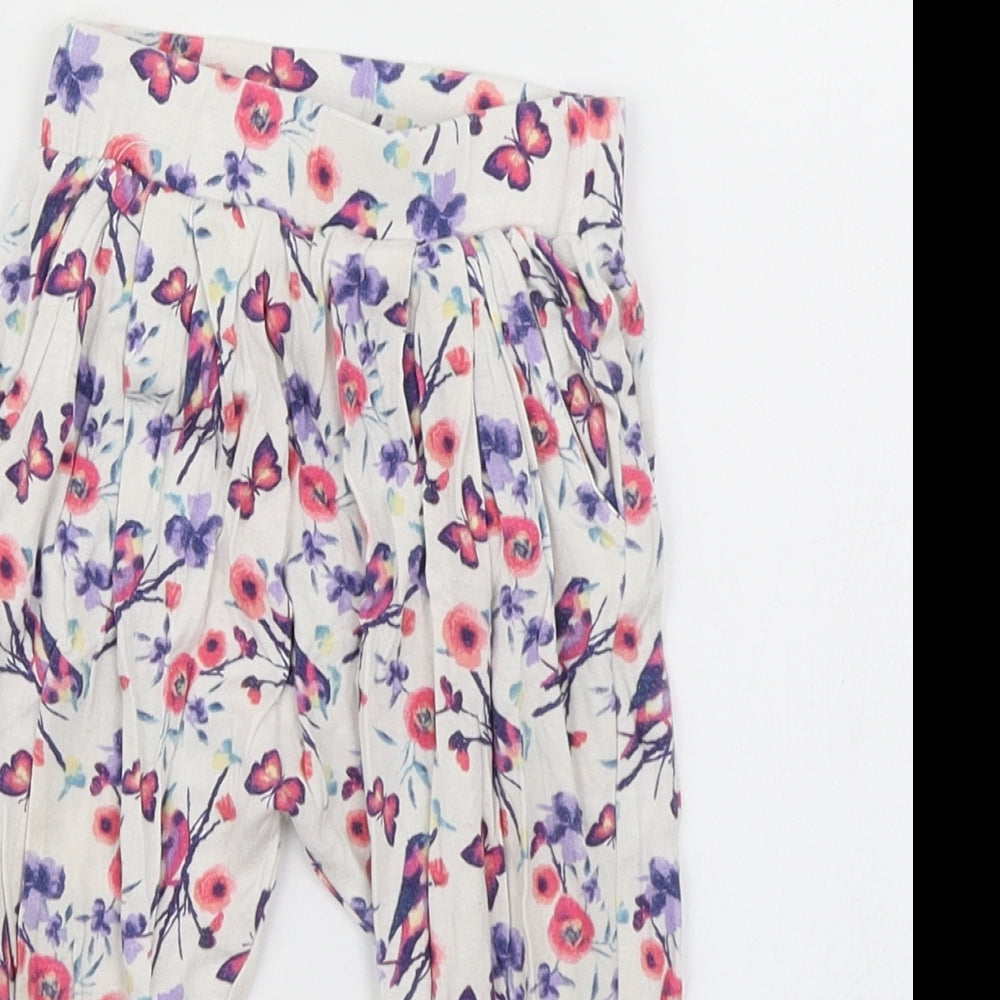 Close-up detail of dymples girls’ white floral jogger trousers, size 12, months