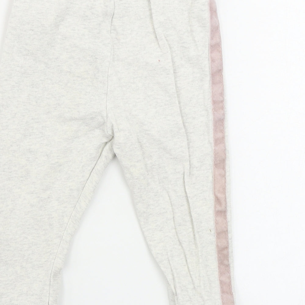 Brand and care label for F&F girls’ beige sweatpants, size 9-12, months