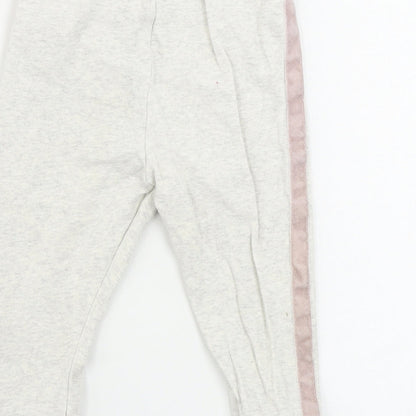 Brand and care label for F&F girls’ beige sweatpants, size 9-12, months