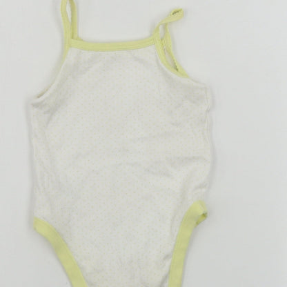 Brand and care label for Nutmeg girls’ white basic tank, size 12-18, months