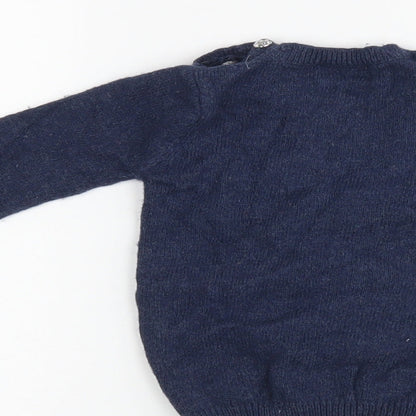 Brand and care label for Next girls’ blue jumper, size 6-9, months