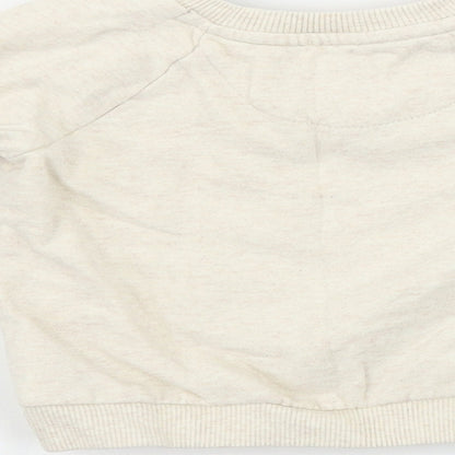 Brand and care label for F&F girls’ beige jumper, size 18-24, months