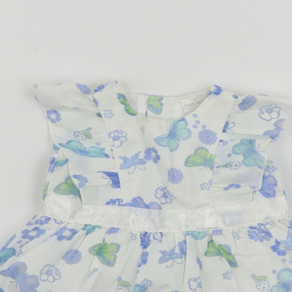 Close-up detail of Baby Boutique girls’ white floral a-line, size 0-3, months