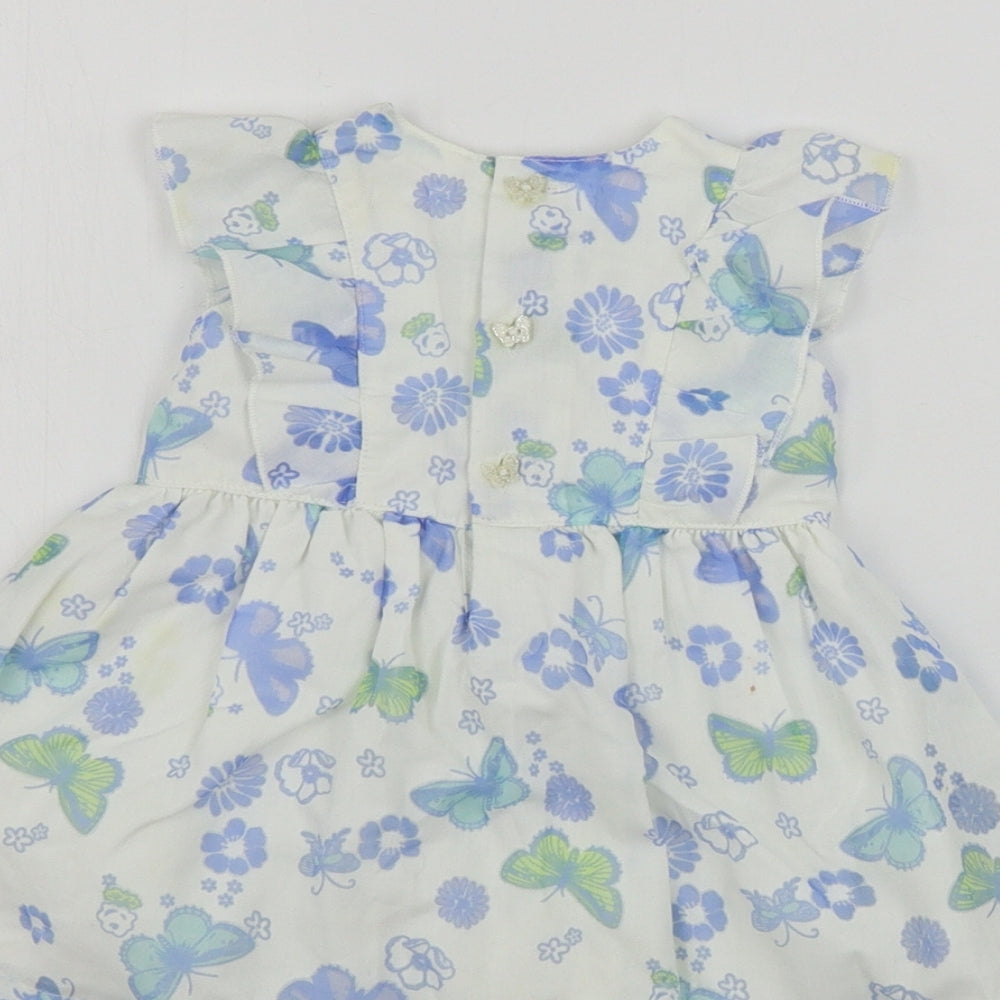 Brand and care label for Baby Boutique girls’ white floral a-line, size 0-3, months