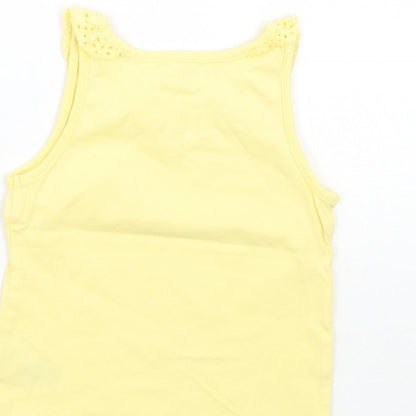Brand and care label for Nutmeg girls’ yellow basic tank, size 12-18, months