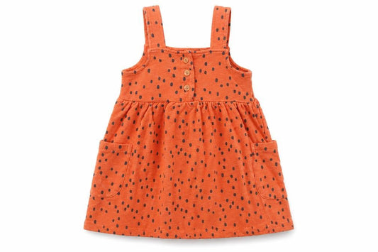 Front view of Nutmeg boys’ orange spotted pinafore/dungaree dress, size 12-18, months