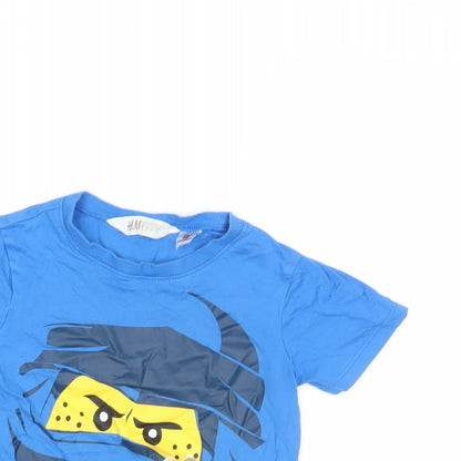 Close-up detail of H&M girls’ blue basic polo, size 2-3, years - lego