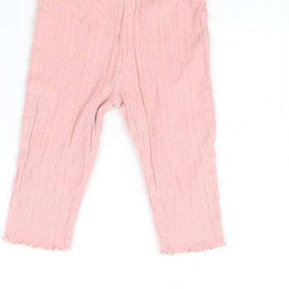 Brand and care label for F&F girls’ pink capri trousers, size 6-9, months