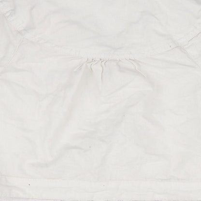 Brand and care label for Next girls’ white overcoat coat, size 3-4, years