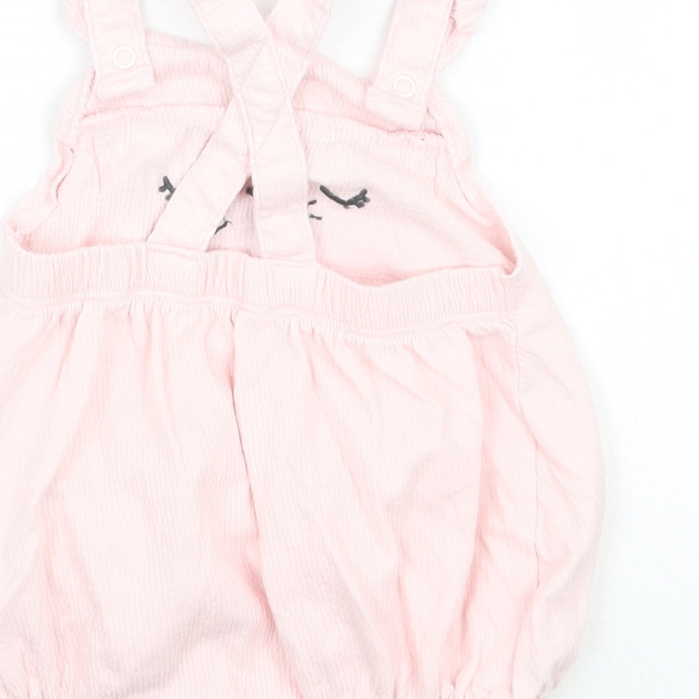 Brand and care label for F&F girls’ pink batik babygrow one-piece, size 3-6, months