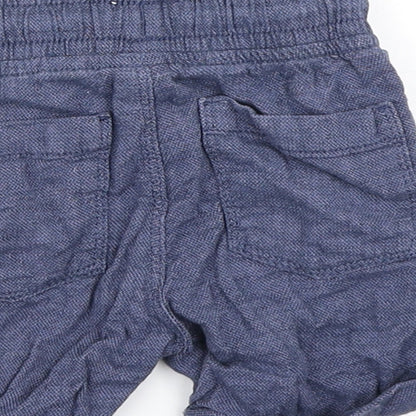 Brand and care label for Tu boys’ blue cropped trousers, size 9-12, months