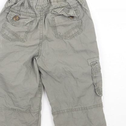 Brand and care label for Pumpkin Patch boys’ green cargo trousers, size 12-18, months