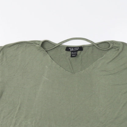 Close-up detail of New Look girls’ green basic blouse, size 14, years