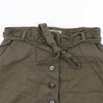 Close-up detail of ASOS women’s green cotton a-line skirt, size UK 10, regular button