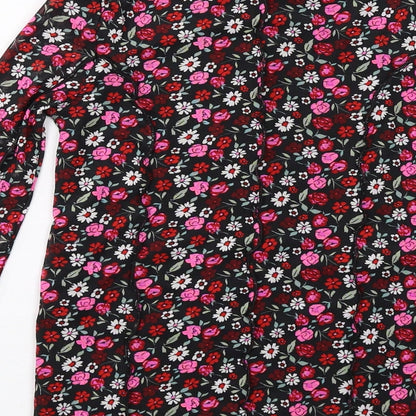 Brand and care label for Marks & Spencer girls’ black floral polyester basic t-shirt, size 10-11, years mock neck pullover