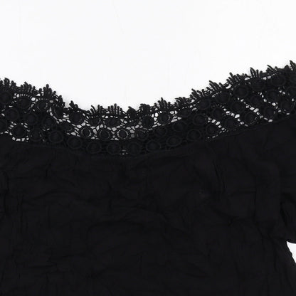 Close-up detail of Miss Selfridge women’s black viscose basic blouse, size UK 10, off the shoulder - crocheted lace trim