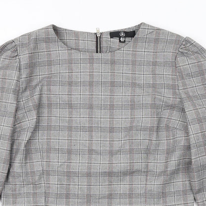 Close-up detail of Missguided women’s grey plaid polyester cropped blouse, size UK 12, boat neck