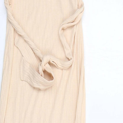 Brand and care label for Missguided women’s beige polyester tank dress, size UK 10, v-neck pullover