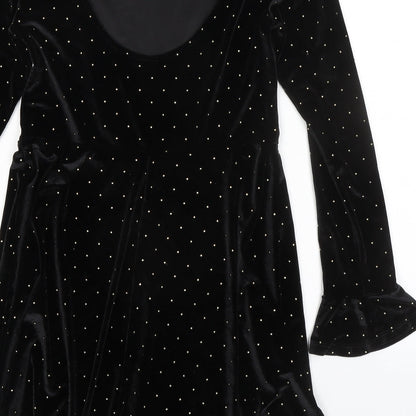 Brand and care label for ASOS women’s black polka dot polyester a-line, size UK 8, round neck pullover
