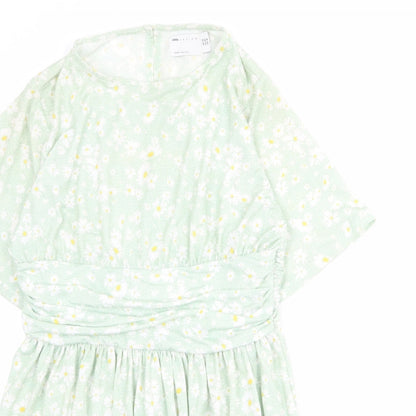 Close-up detail of ASOS women’s green floral polyester mini, size UK 14, round neck button