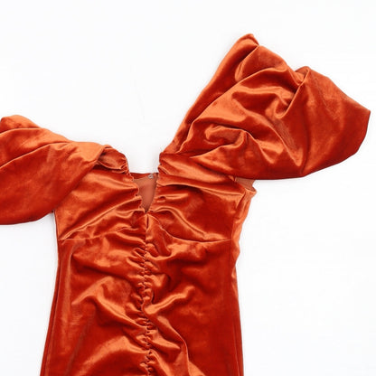 Close-up detail of ASOS women’s orange polyester mini, size UK 4, one shoulder zip
