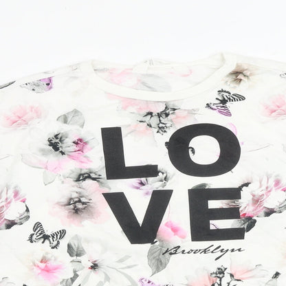 Close-up detail of H&M girls’ white floral cotton basic blouse, size 11-12, years crew neck pullover