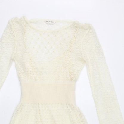 Close-up detail of Miss Selfridge women’s ivory acrylic fit & flare, size UK 10, boat neck pullover