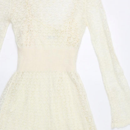 Brand and care label for Miss Selfridge women’s ivory acrylic fit & flare, size UK 10, boat neck pullover