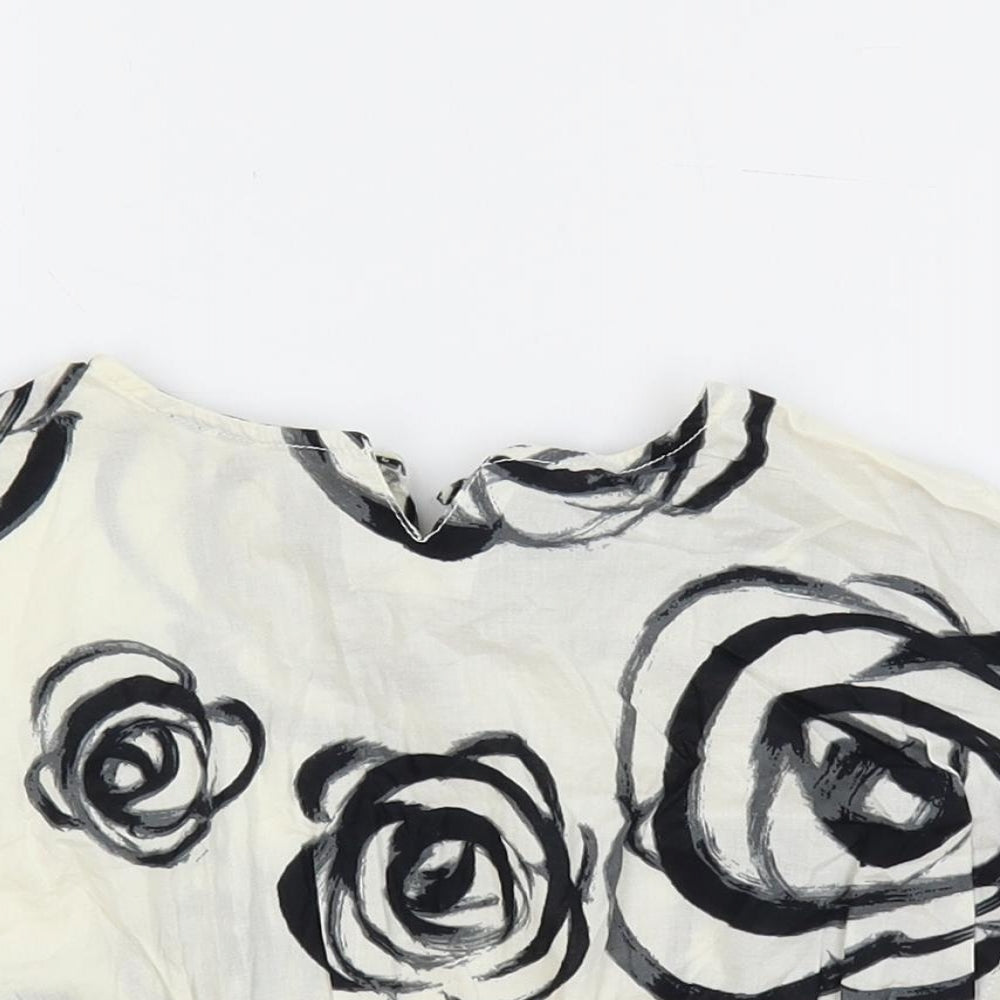 Close-up detail of Gap girls’ ivory floral cotton pullover blouse, size 18-24, months round neck button