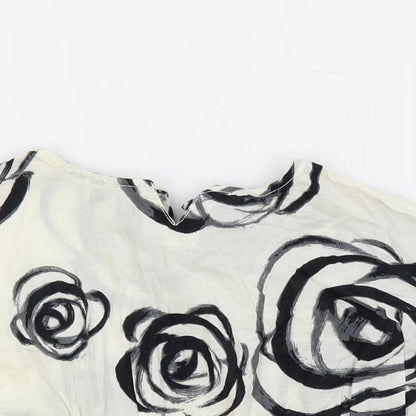 Close-up detail of Gap girls’ ivory floral cotton pullover blouse, size 18-24, months round neck button