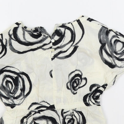 Brand and care label for Gap girls’ ivory floral cotton pullover blouse, size 18-24, months round neck button
