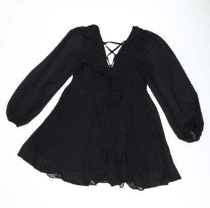 Back view of ASOS women’s black polka dot polyester shift, size UK 10, v-neck zip
