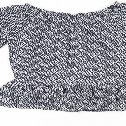 Brand and care label for Next girls’ blue floral polyester basic blouse, size 10, years off the shoulder pullover