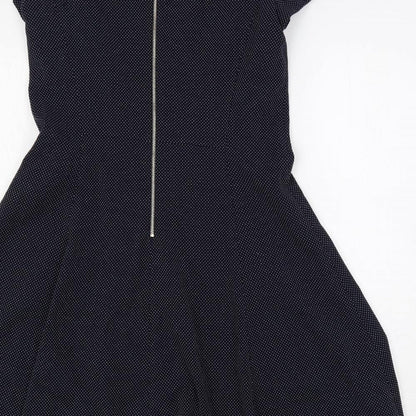 Brand and care label for ESPRIT women’s blue polka dot polyester fit & flare, size UK 10, round neck zip