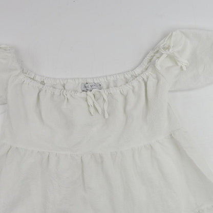Close-up detail of In the Style women’s white polyester mini, size UK 10, off the shoulder pullover