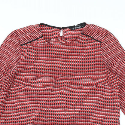 Close-up detail of Dunnes women’s red geometric polyester basic blouse, size XS, round neck
