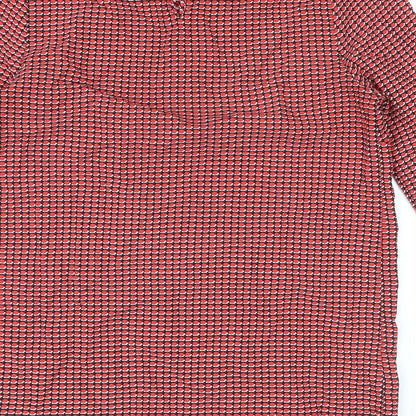 Brand and care label for Dunnes women’s red geometric polyester basic blouse, size XS, round neck