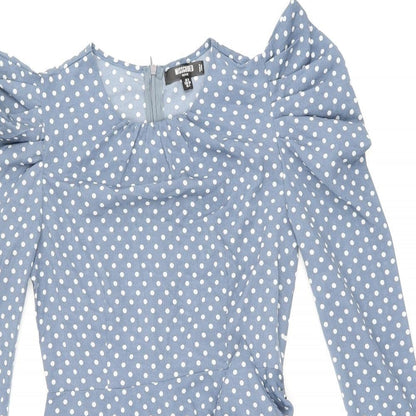 Close-up detail of Missguided women’s blue polka dot polyester bodycon, size UK 8, round neck zip