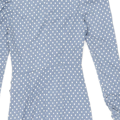 Brand and care label for Missguided women’s blue polka dot polyester bodycon, size UK 8, round neck zip